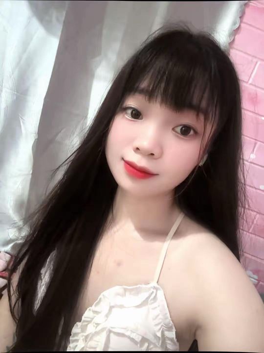 Smiling woman looking at the camera during a live girl video call